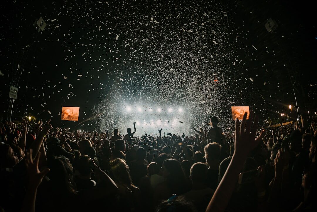 Crowd at a concert with bright stage lights