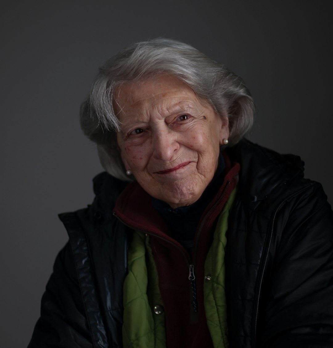 Studio portrait of a smiling woman with light hair