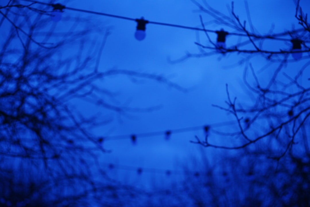 Bright concert stage lights against dark sky